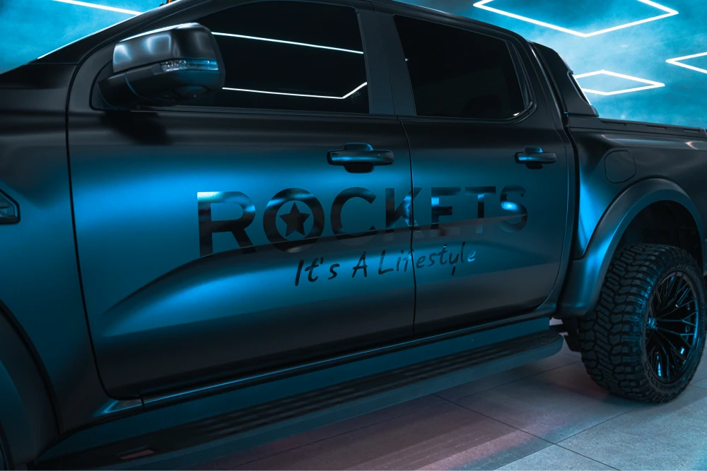 Dark blue pickup truck with Rockets branding and the slogan 'It's A Lifestyle' on the door panel.